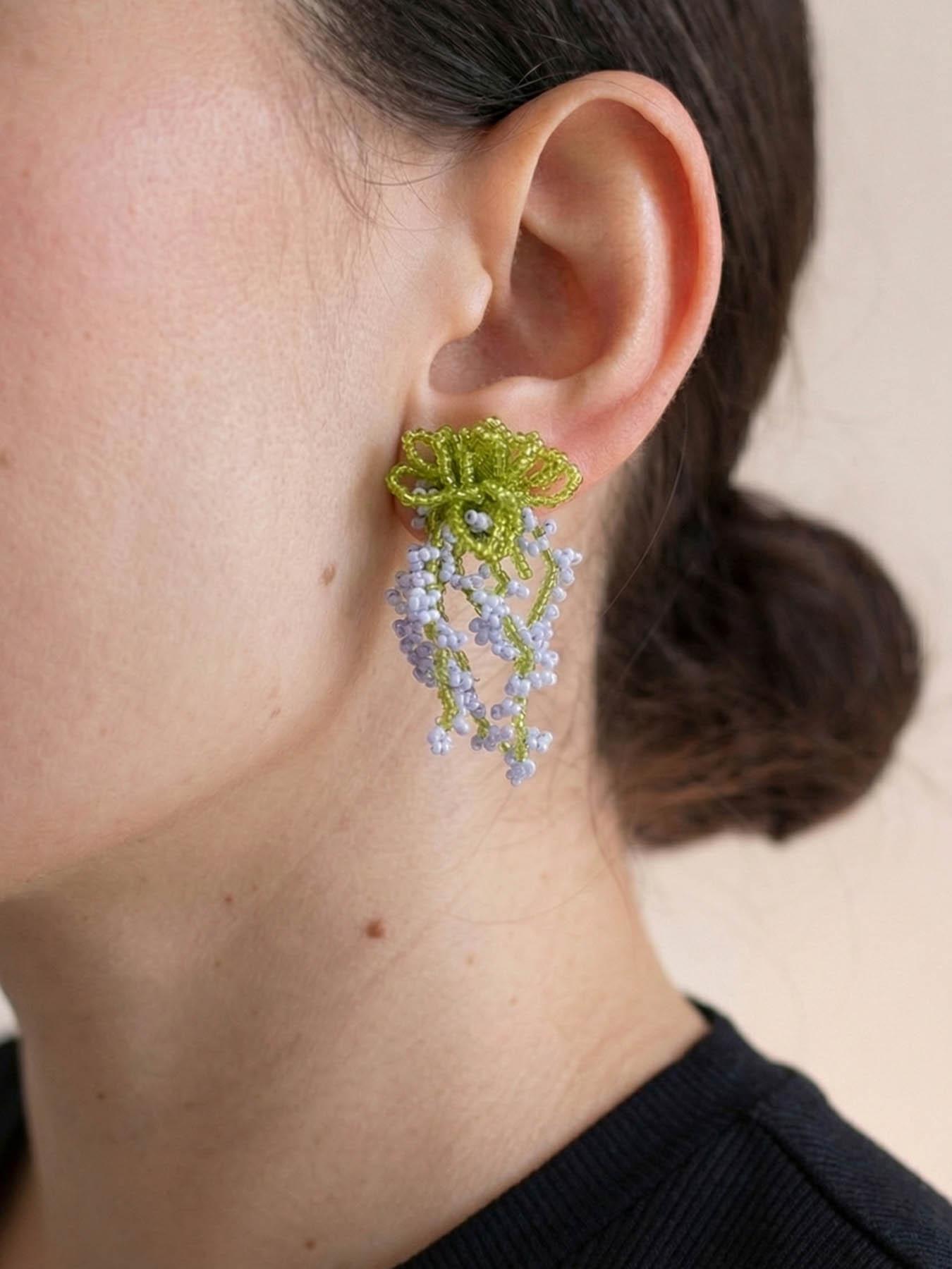 A pair of glass bead fringe earrings featuring a floral waterfall design, handcrafted earrings with a fresh, sweet style, perfect for a laid-back summer beach vacation look