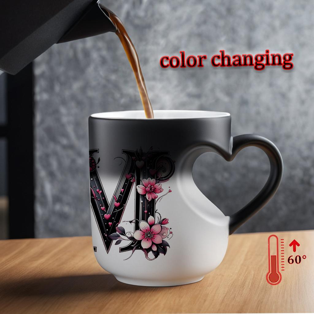 Heat-changing ceramic mug with pink butterfly and floral motif, heart-shaped handle, 11 oz/330 ml capacity. This color-changing thermos is perfect for hot and cold beverages.