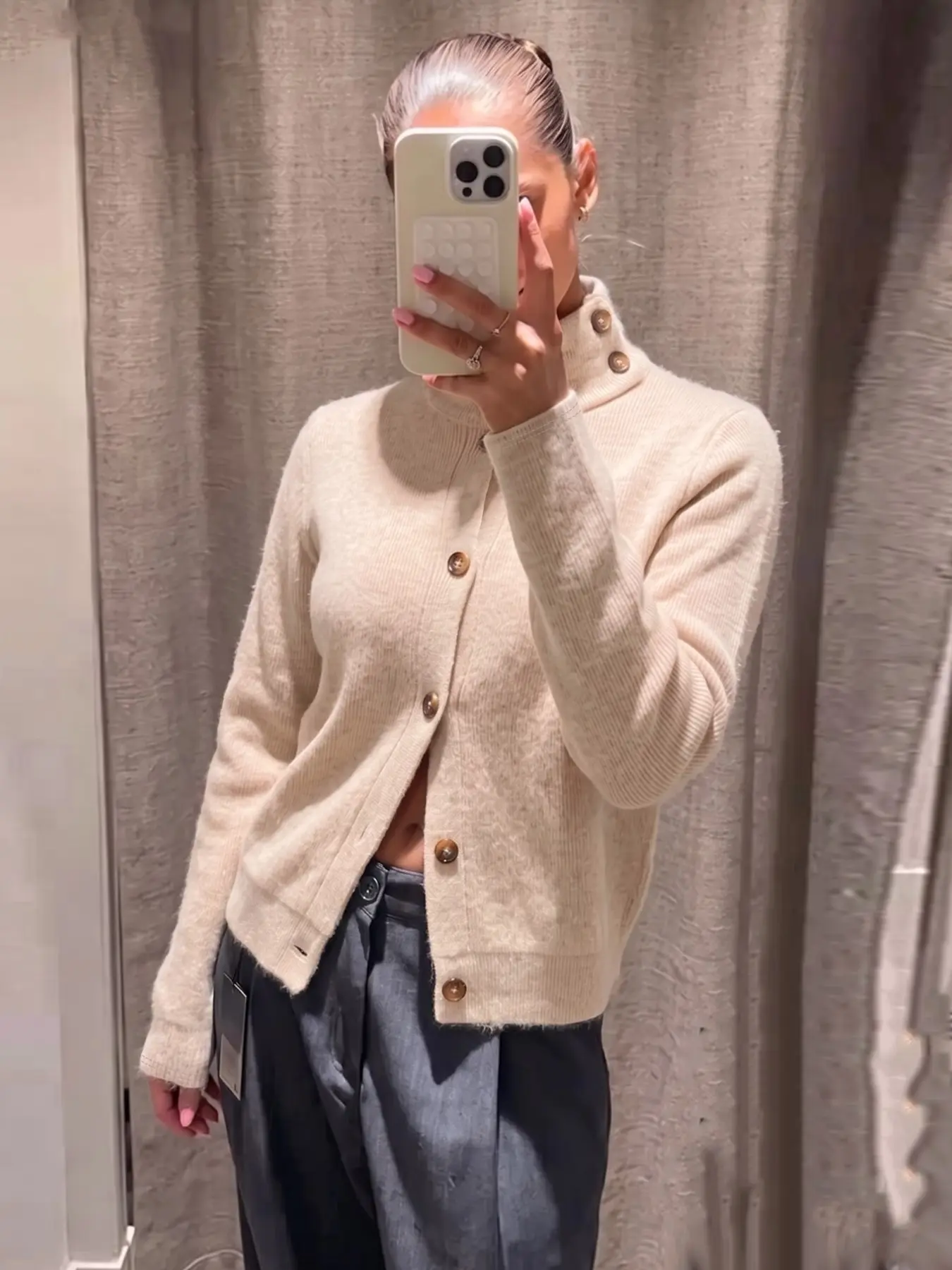 Women's ribbed knit cardigan with a high neck and button-front design; a minimalist cream-colored Casual long-sleeve jacket.