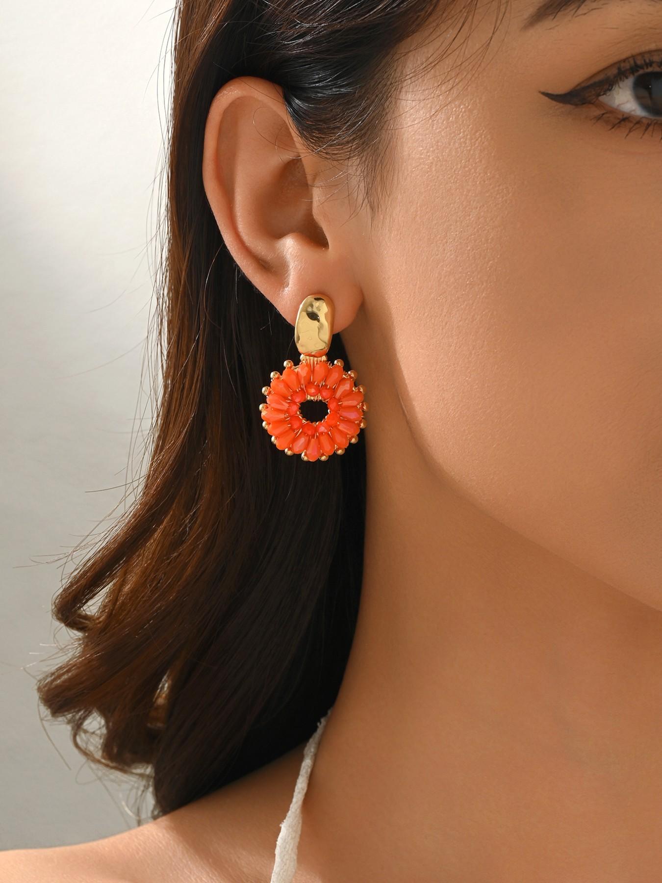 A pair of handcrafted, beaded dangle earrings featuring a chic Bohemian resort style. These round earrings exude an elegant, refined, and understated aesthetic with a premium feel, available in a variety of colors. for women to wear on any occasio