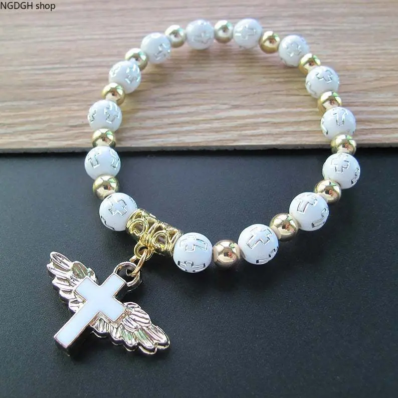 Religious Cross Beaded Bracelet with Angel Wings Charm, White Gold Acrylic Stretch Prayer Wristband, Elegant Faith Symbol Jewelry, Meaningful Communion Baptism Gift, Perfect for Women, Girls & Daily Spiritual Wear.