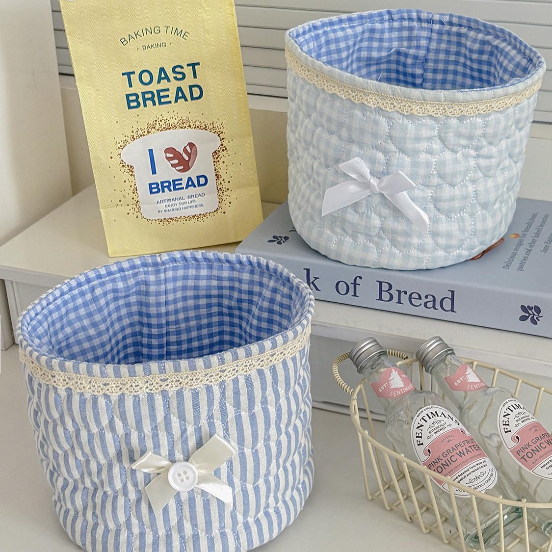 Cute lace bow patchwork storage basket, round fabric desktop organizer box, Instagram-style plaid print storage bin, soft padded makeup storage box, attractive pink bow storage bucket, foldable desktop storage basket