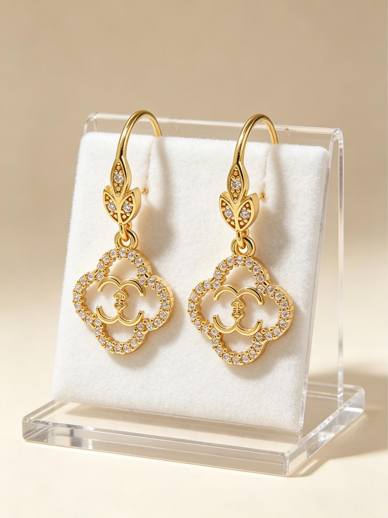 A pair of openwork flower earrings, delicate four-leaf clover earrings, and luxurious copper earrings inlaid with zircon