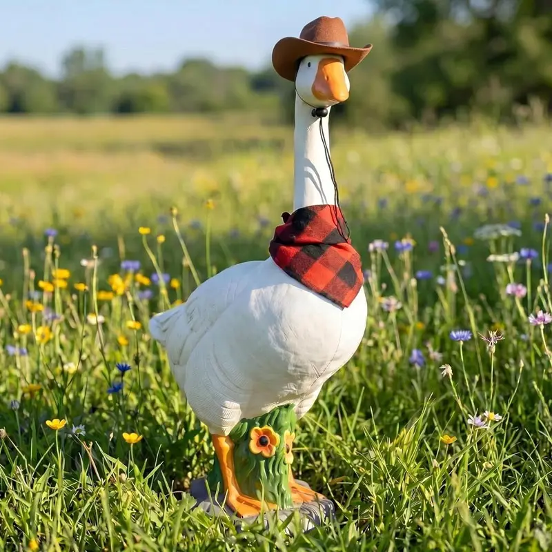One hollow resin garden goose, equipped with a detachable cowboy hat and scarf, with a design for filling with sand, suitable for stable outdoor placement. It is a home decoration item suitable for use in gardens, courtyards or entrances.