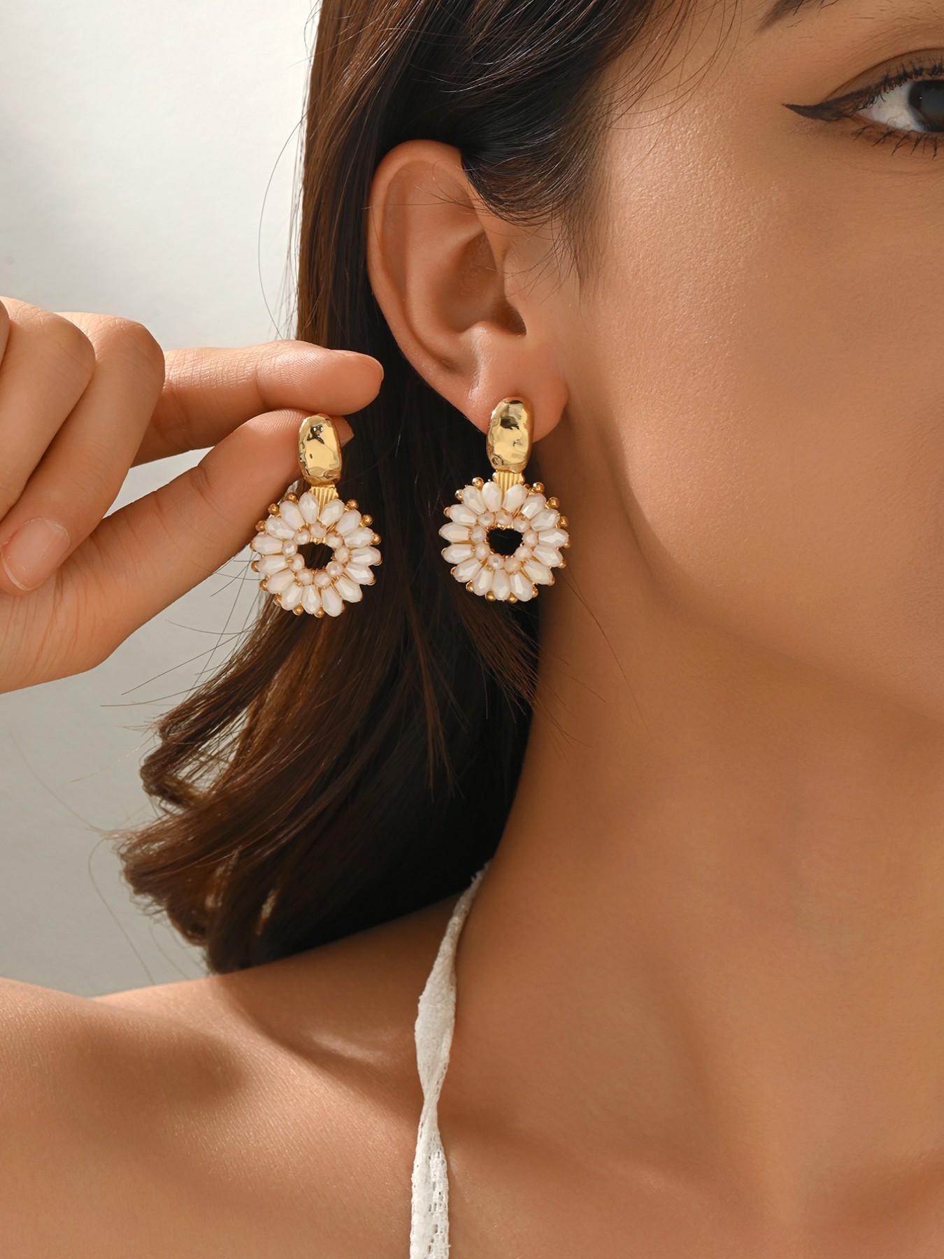 A pair of handcrafted, beaded dangle earrings featuring a chic Bohemian resort style. These round earrings exude an elegant, refined, and understated aesthetic with a premium feel, available in a variety of colors. for women to wear on any occasio