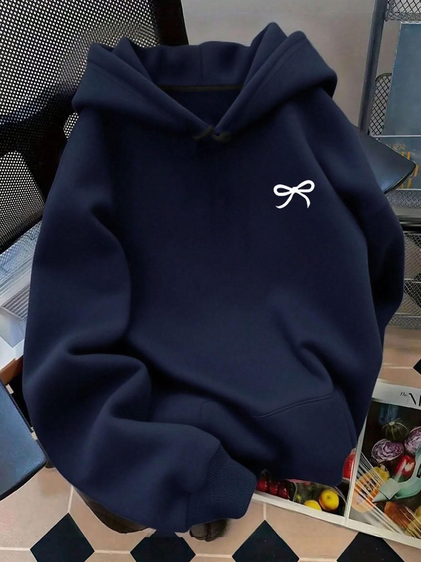 Soft fleece-lined, relaxed-fit graphic style with a bowknot, kangaroo pocket and adjustable drawstring hood. This on-trend hoodie sweatshirt pullover is perfect for versatile daily casual wear in fall and winter.