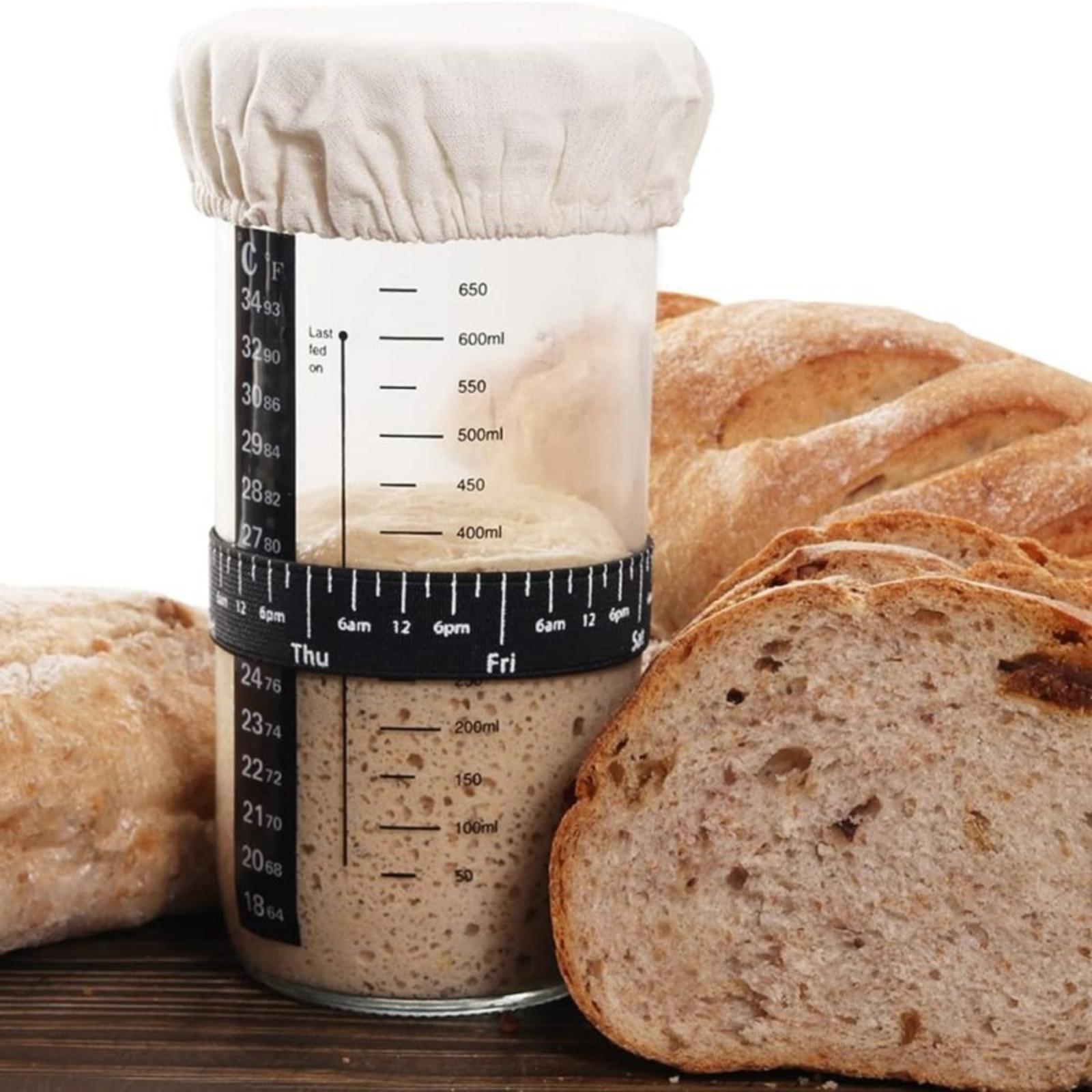 Bread fermentation jar, labeled feeding belt, thermometer, scraper, cloth cover and silicone cover/base, glass container, baking supplies