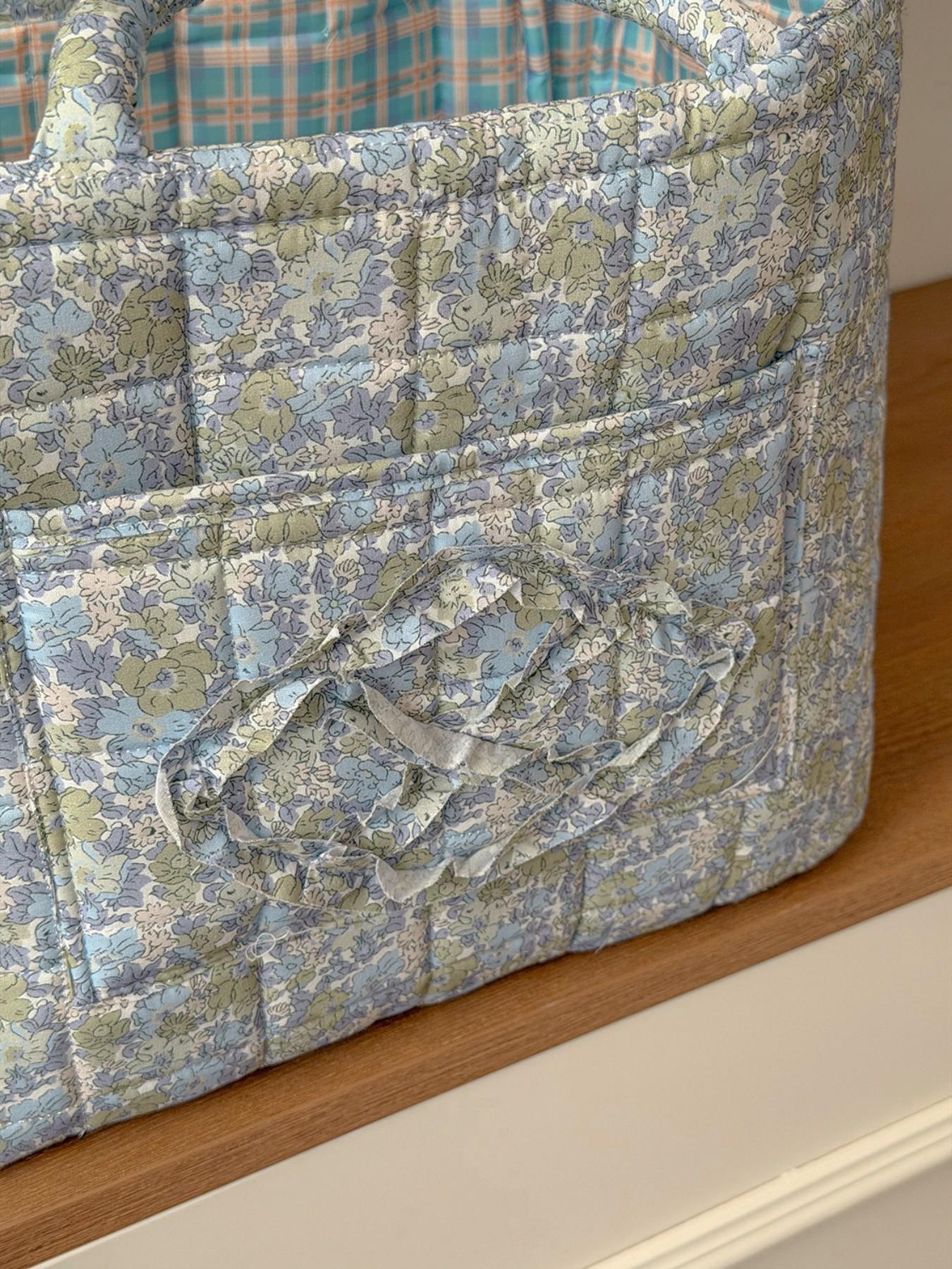 Large capacity floral quilted storage basket with plaid lining and multi-purpose organizer to store makeup, toiletries and daily essentials, perfect for bedrooms, bathrooms, offices and travel