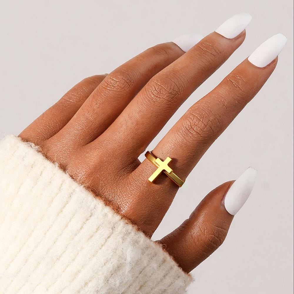 Exclusive and moderately luxurious cross-shaped open ring for couples. A pair of stainless steel jewelry for hands.