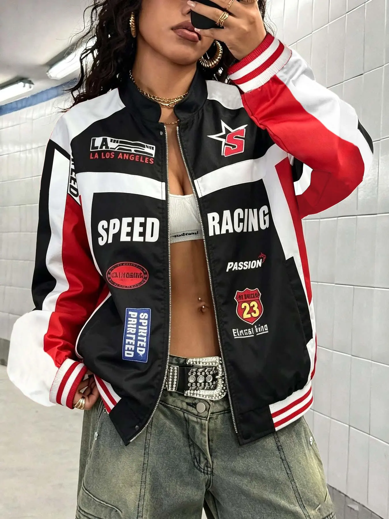 Unisex black and red color-block racing bomber jacket with multiple patches and letter prints, zip-up style, made from lightweight and comfy fabric. Perfect for streetwear, skateboarding, music festivals, and casual hangouts.