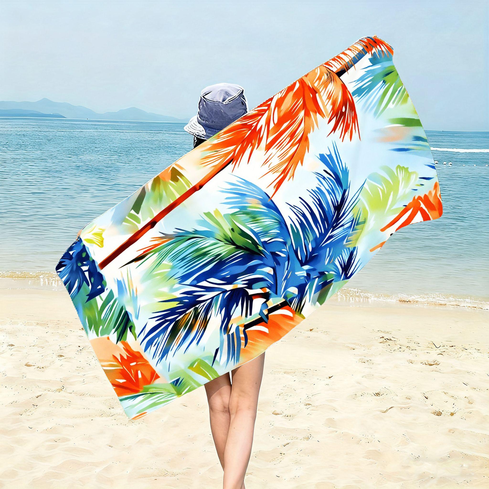 A Large Beach Towel Featuring a Colorful Palm Leaf Design (Light Blue Background with Blue, Green, And Orange Colors) with Sand-Resistant Features. It Is Soft, Lightweight, And Quick-Drying, Perfect For, Travel, And Outdoor Settings