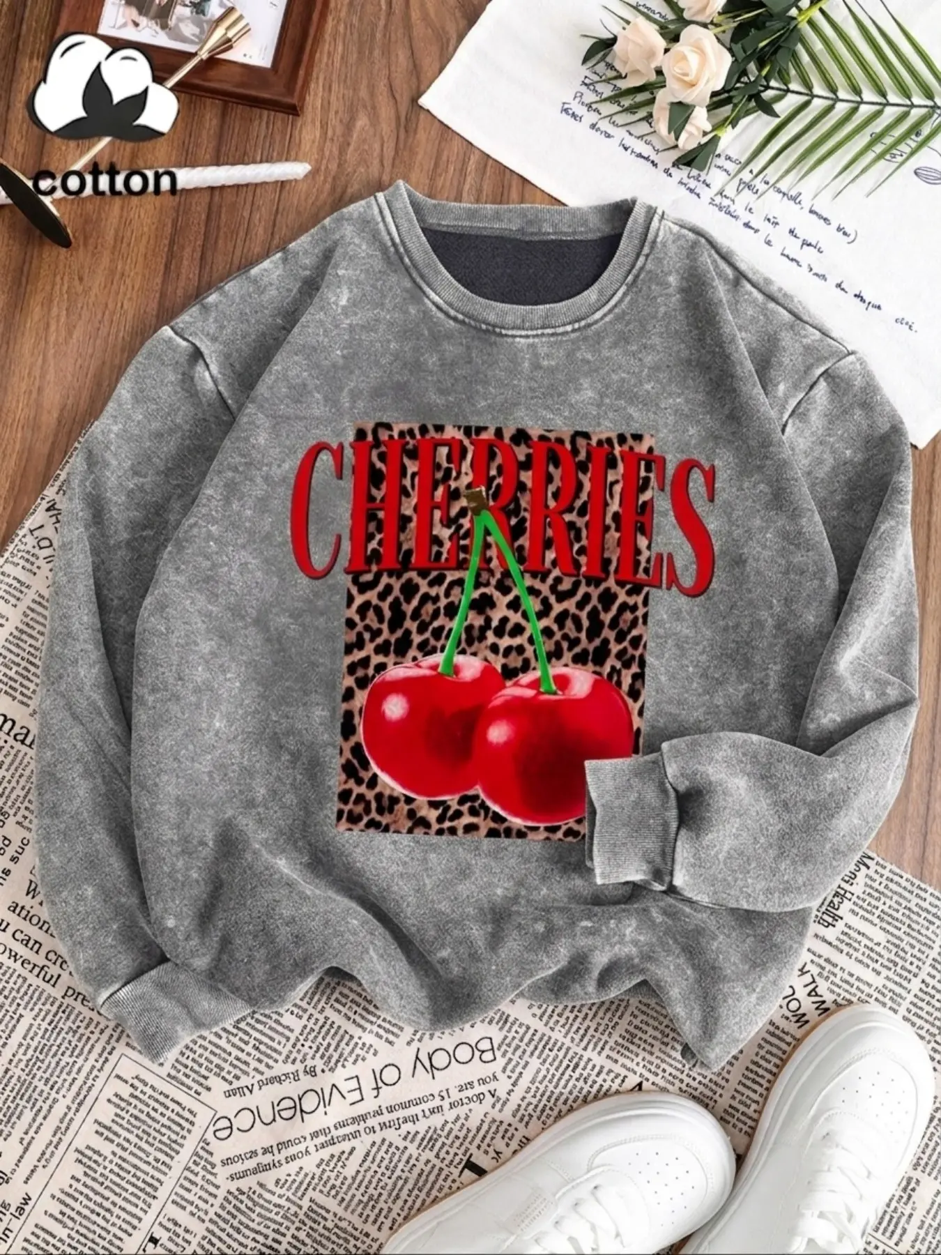 Cotton garment: a casual, vintage-style washed cotton long-sleeve pullover for women, featuring a cherry and leopard print, a crew neck, and a fleece lining—perfect for autumn and winter.