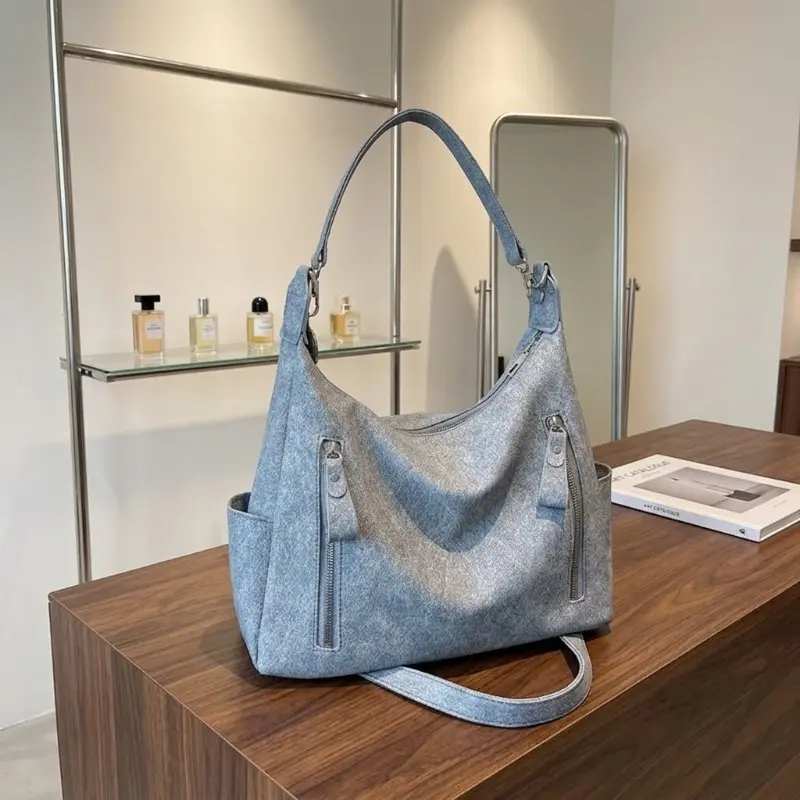 Stylish, high-capacity PU leather crossbody bag—convertible to a shoulder bag or multi-pocket tote—featuring a detachable, adjustable strap; suitable for daily use