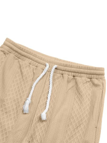 Men's knitted suit. The top features a half-placket and a high neckline, paired with simple and practical buttons. The brown elbow patches create a color contrast and match the drawstring jogger pants in the same color family. The fabric is thick.