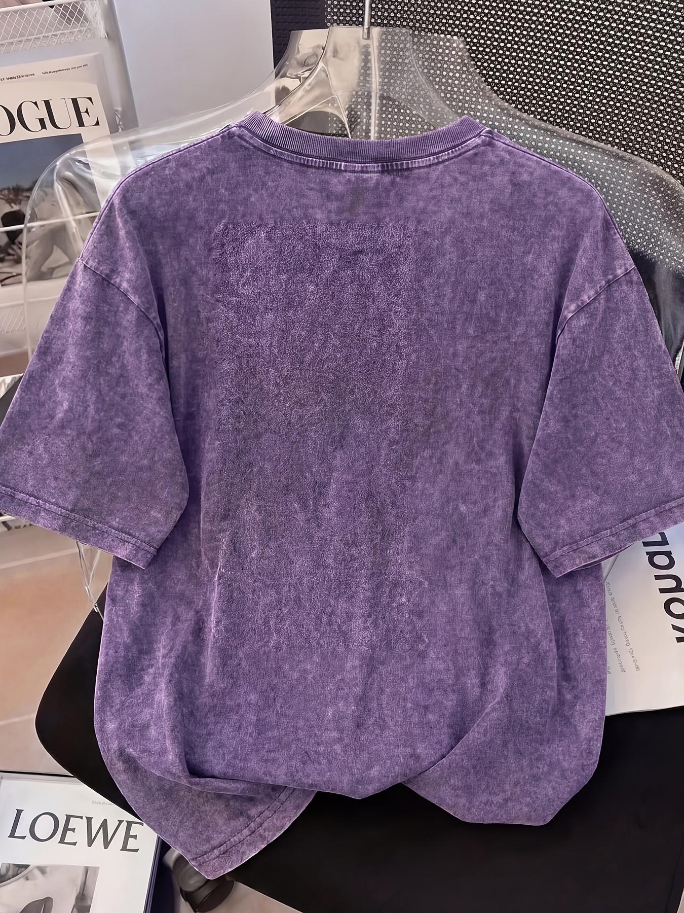 Distressed T-shirt featuring a colorful portrait print of an African woman; relaxed American style with soft, vintage-wash cotton fabric—perfect for pairing with denim shorts or wide-leg trousers for a casual street-style look Streetwear