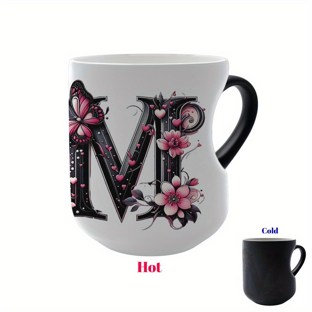 Heat-changing ceramic mug with pink butterfly and floral motif, heart-shaped handle, 11 oz/330 ml capacity. This color-changing thermos is perfect for hot and cold beverages.