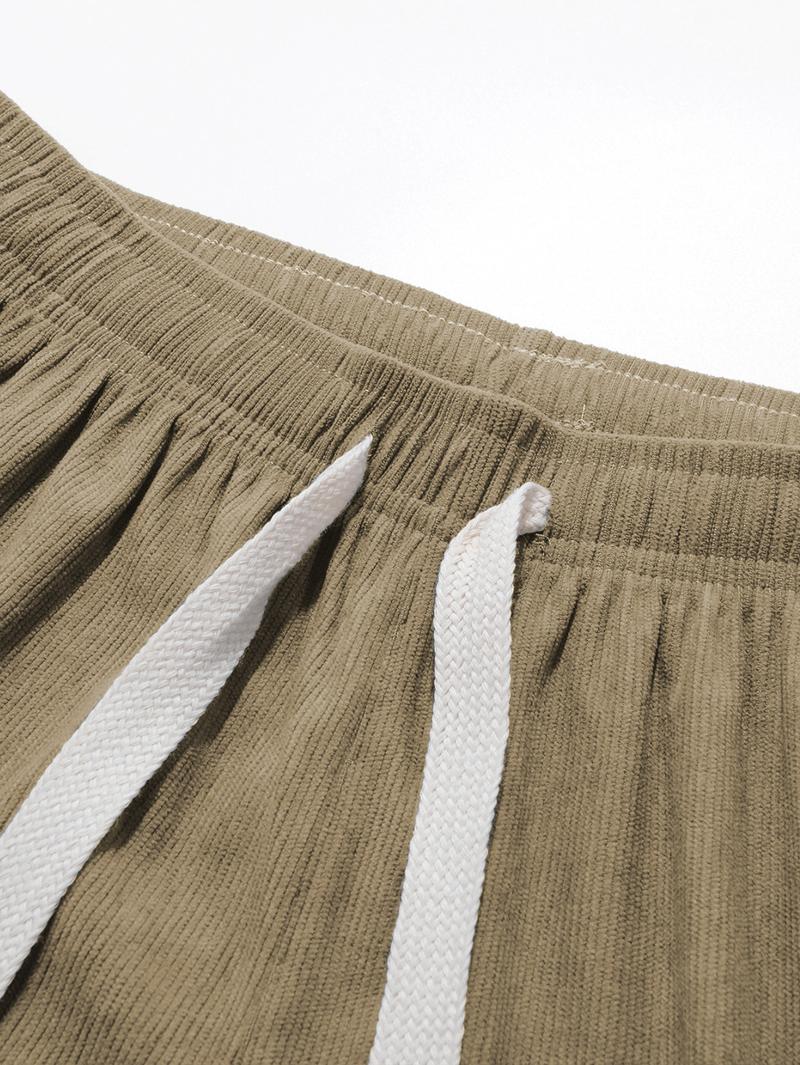 Two men's casual pants featuring a simple and versatile style with drawstring design, adding a casual feel. The pants have delicate small details, making them full of texture. The loose fit provides comfortable and relaxed wear, suitable for everyday outi