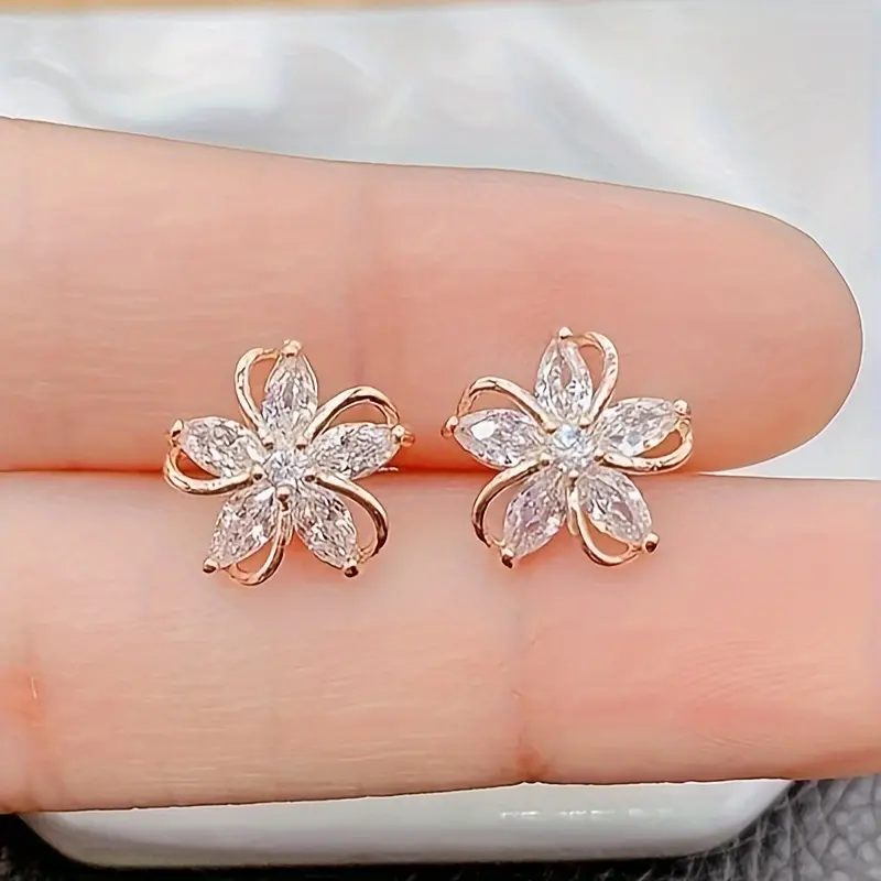 A pair of elegant vintage-inspired five-petal flower stud earrings embellished with sparkling rhinestones, perfect for everyday wear or as a thoughtful gift for women, sisters, and loved ones.
