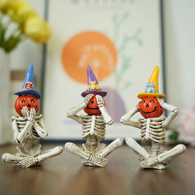 A set of 3 resin skull and pumpkin figurines. No sound - no words - no sight of the figurines. Gothic style Halloween decorative indoor items.