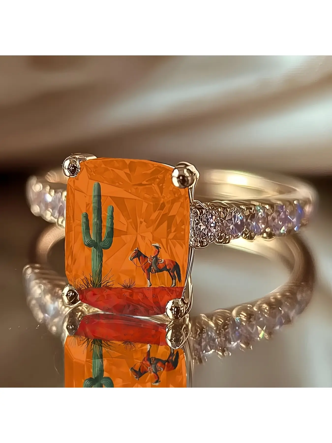 Orange background desert cowboy riding a horse cactus print square ring, American Western wilderness art scene, full of free atmosphere, a niche decorative jewelry for outdoor enthusiasts as a commemorative gift