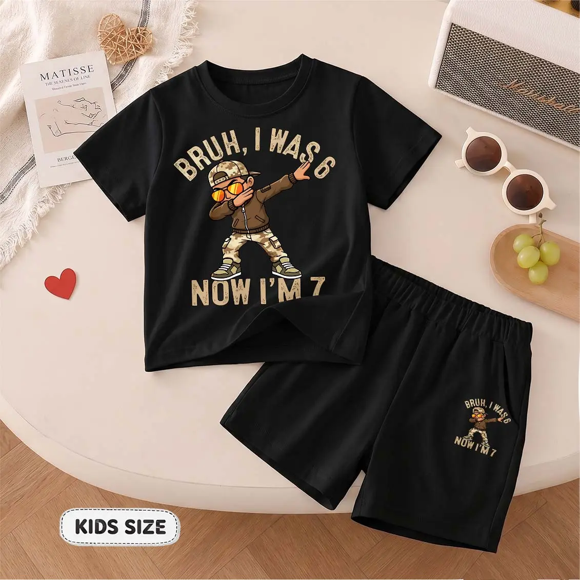 Kids’ “Bruh, I was 6, now I'm 7” Cartoon Print Short-Sleeve T-Shirt And Shorts Set—Casual Summer Kids' Clothing. This Round-Neck Outfit Combination Is Perfect For Everyday Wear And Outdoor Play.
