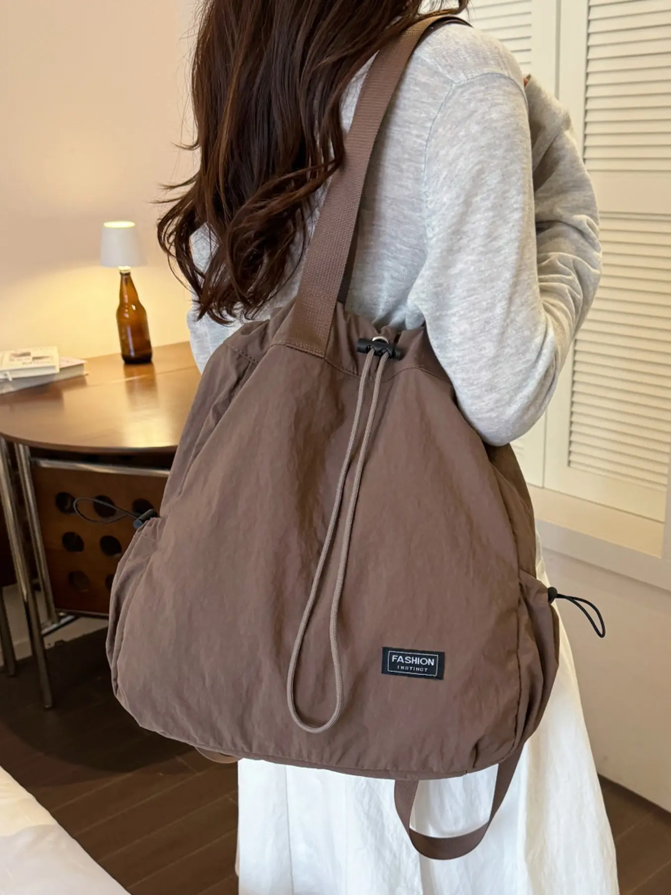 1pc Ladies' drawstring nylon backpack with rope cloth tag decoration, large capacity lightweight daily backpack for campus commuting, short distance travel, simple casual wear essential item