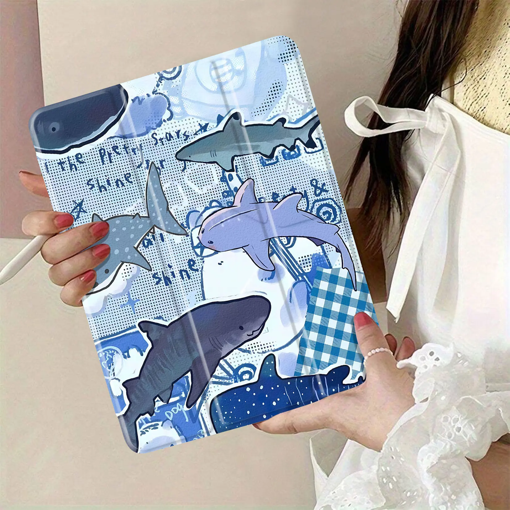 cartoon shark-themed fabric suitable for crafting and sewing projects; features various shark illustrations in playful colors; perfect for making clothing, accessories, or home decor items; great for kids and marine life enthusiasts