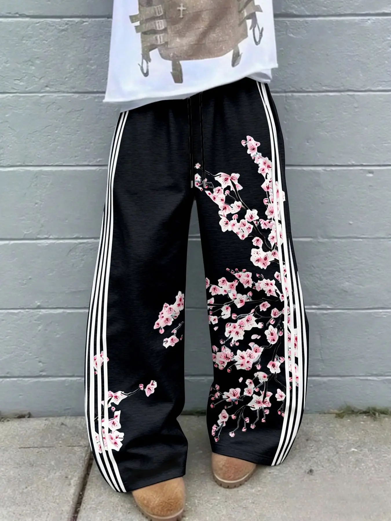 Men's Black Cherry Blossom Track Pants, Baggy Wide-Leg Drawstring Sweatpants with Pink Floral Branch Graphics, White Side Stripes and Relaxed Straight Legs, Retro Y2K Streetwear for Campus, Skate, Travel, Festivals, Parties and Casual Wear.