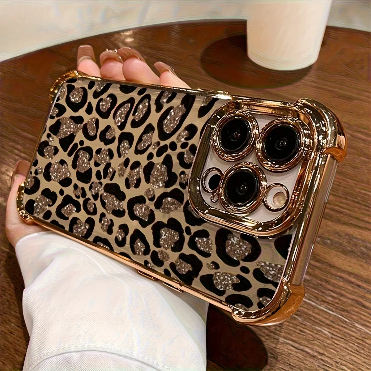 Electroplated phone case featuring a sparkling rhinestone leopard print, shock-absorbing corners, and a non-slip, full-coverage TPU design with lens protection; compatible with iPhone 17, 16, 15, 14, 13, 12, 11, XS, X, and other series models.