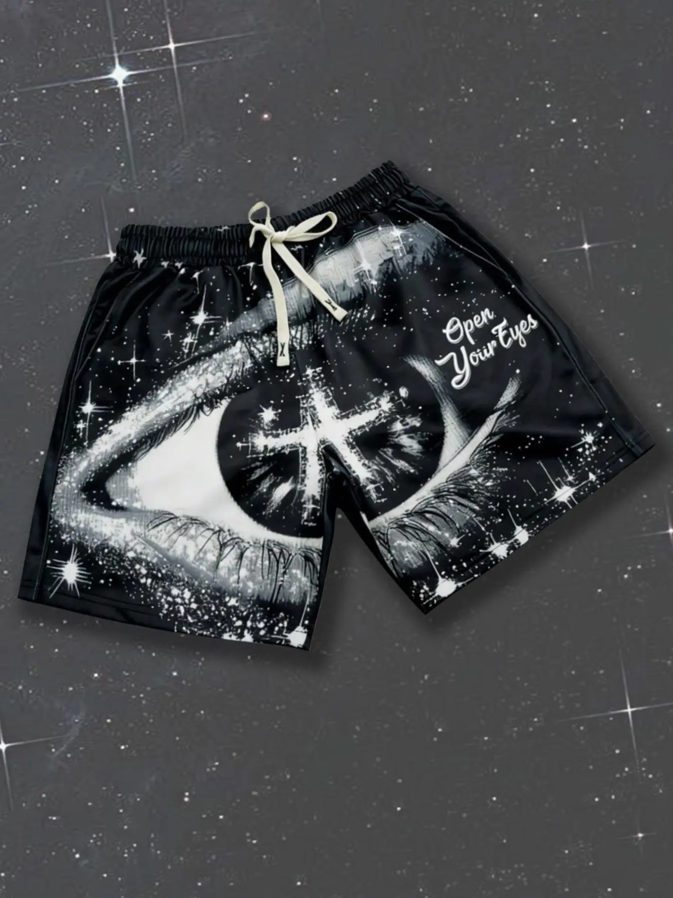 "Eye of Holy Light" print casual streetwear Oversized shorts—featuring a cross-pupil and starry sky motif. These versatile black unisex athletic shorts offer a loose, breathable fit with an elastic drawstring waist, perfect for everyday street style.