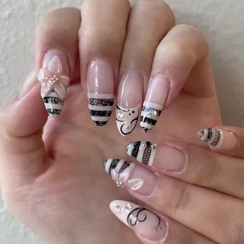 French almond-shaped press-on nails, Decorative nails, featuring black and pink lace stripes, 3D gelx nails hand-painted floral art with white rhinestone, and heart accents perfect for wedding season