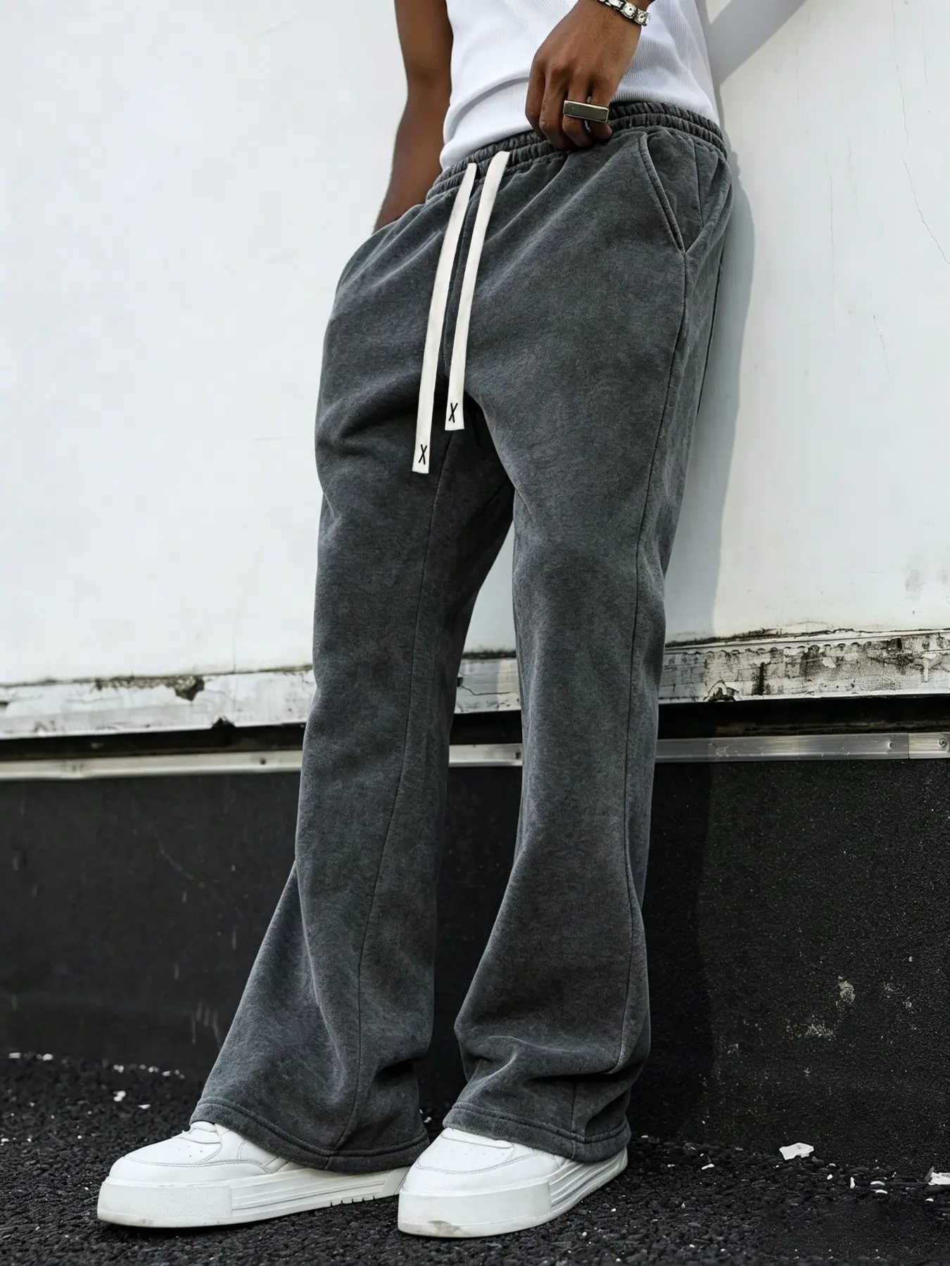 Men's sweatpants featuring a washed, distressed finish and cotton fabric; designed with a slight flare cut, these lightweight, casual pants offer a versatile, essential style.