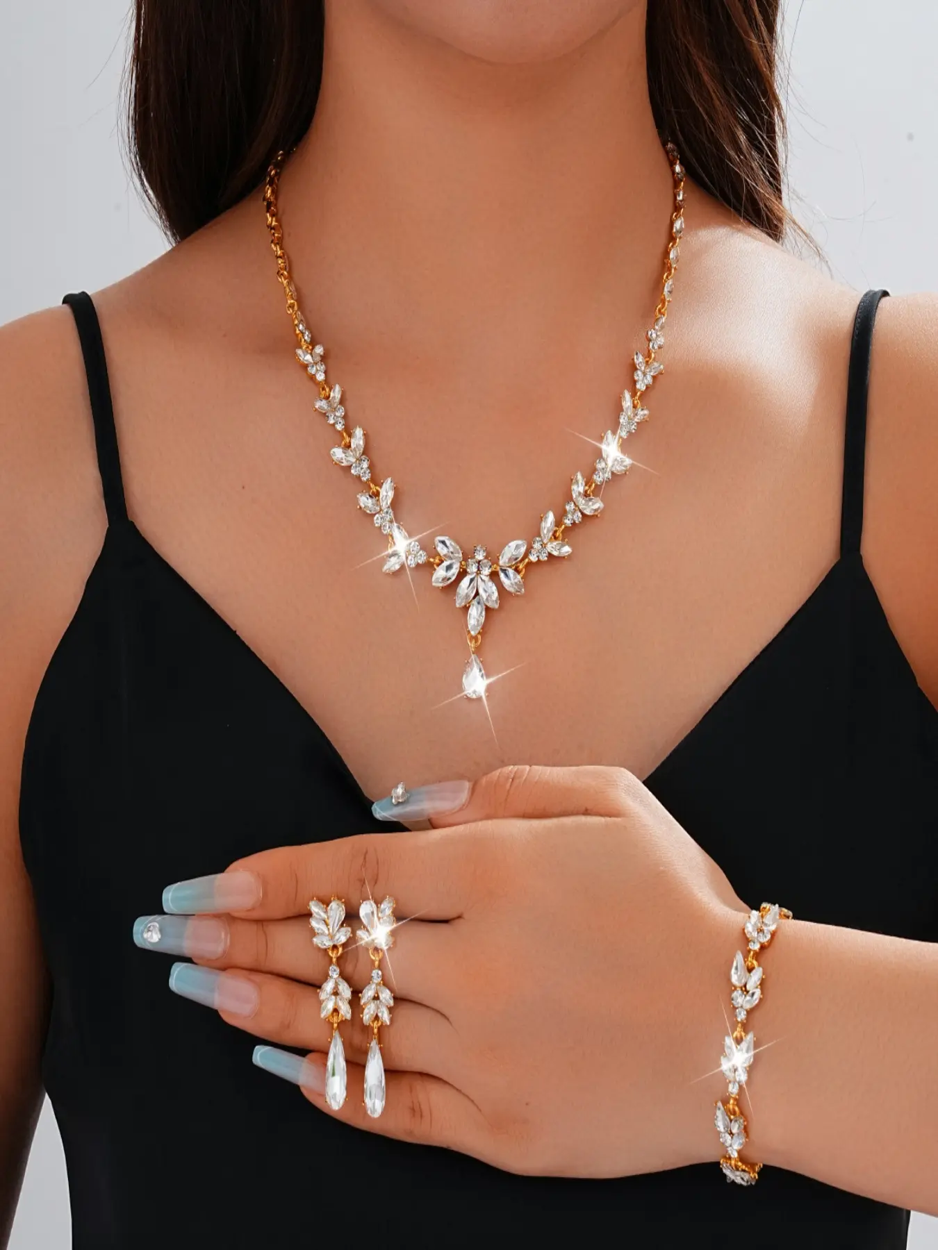 Three-piece luxurious and elegant women's jewelry set, including a bracelet, necklace, and earrings, adorned with floral sequins and sparkling rhinestones, suitable as a wedding or Valentine's Day gift