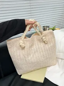 Fashionable and minimalist vacation-style straw handbag with a knotted handle design, lightweight and spacious tote for commuting