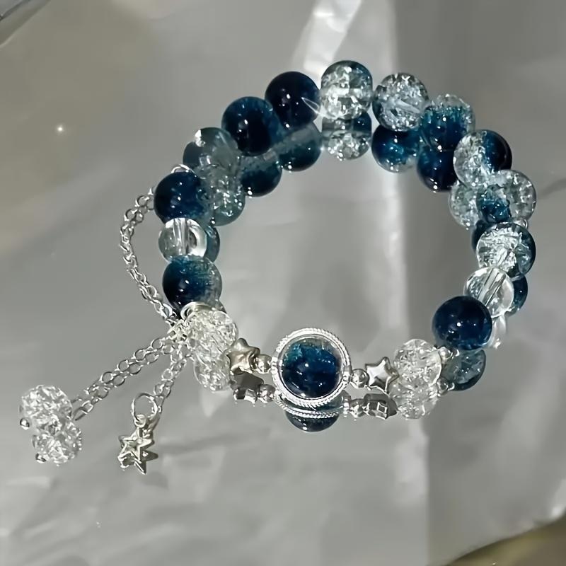 An elegant glass bead bracelet featuring a star pendant-a sophisticated, faux cat's-eye style accessory suitable for women and individuals aged 15 and up. Perfect for Valentine's Day, Carnival, and Christmas parties.