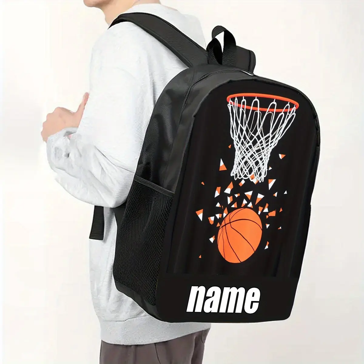 Personalized Name Customization: Basketball Theme Backpack. This large-capacity (17-inch) casual backpack features a vibrant cartoon design and can also be used as a laptop bag. It comes with a water bottle pocket and adjustable shoulder straps.