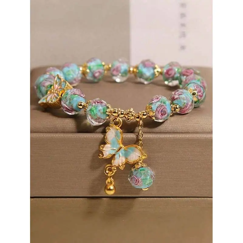 Bohemian style pink rose glass bead bracelet, featuring a blue butterfly pendant, handcrafted using the oil-dripping technique, skin-friendly jewelry, suitable for daily wear and as a gift