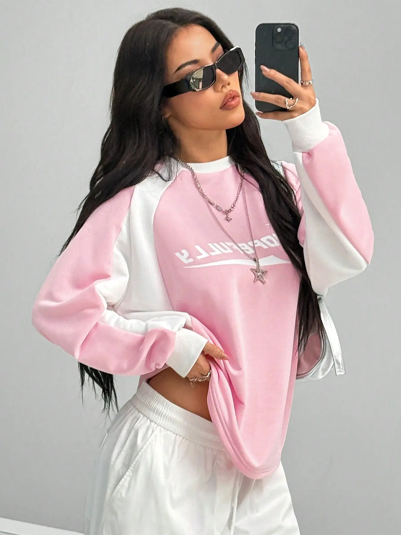 Y2K pink patchwork sleeve sweatshirt, a pullover long-sleeve top with letter print color block, casual loose streetwear, soft everyday wear, vintage collegiate style lightweight crewneck, perfect for casual hangouts and street photos