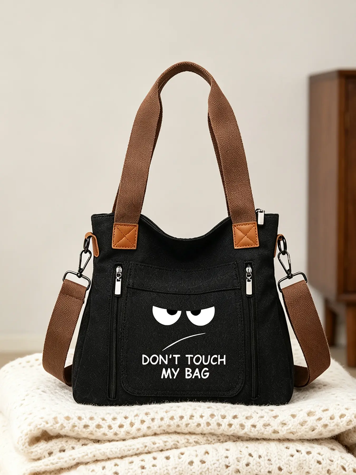 Fashion tote bag printed with angry face and words "DON'T TOUCH MY BAG". Large-capacity minimalist shoulder & crossbody bag with zipper closure, ideal work bag for students and adults.