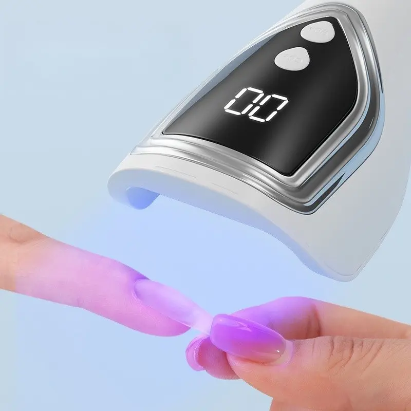 A portable rechargeable UV LED nail drying lamp - a handheld mini gel polishing and curing lamp with a digital display, ergonomic design for quick and easy nail art, USB rechargeable, white, gel polisher | modern nail lamp | gloss finish, nail polish