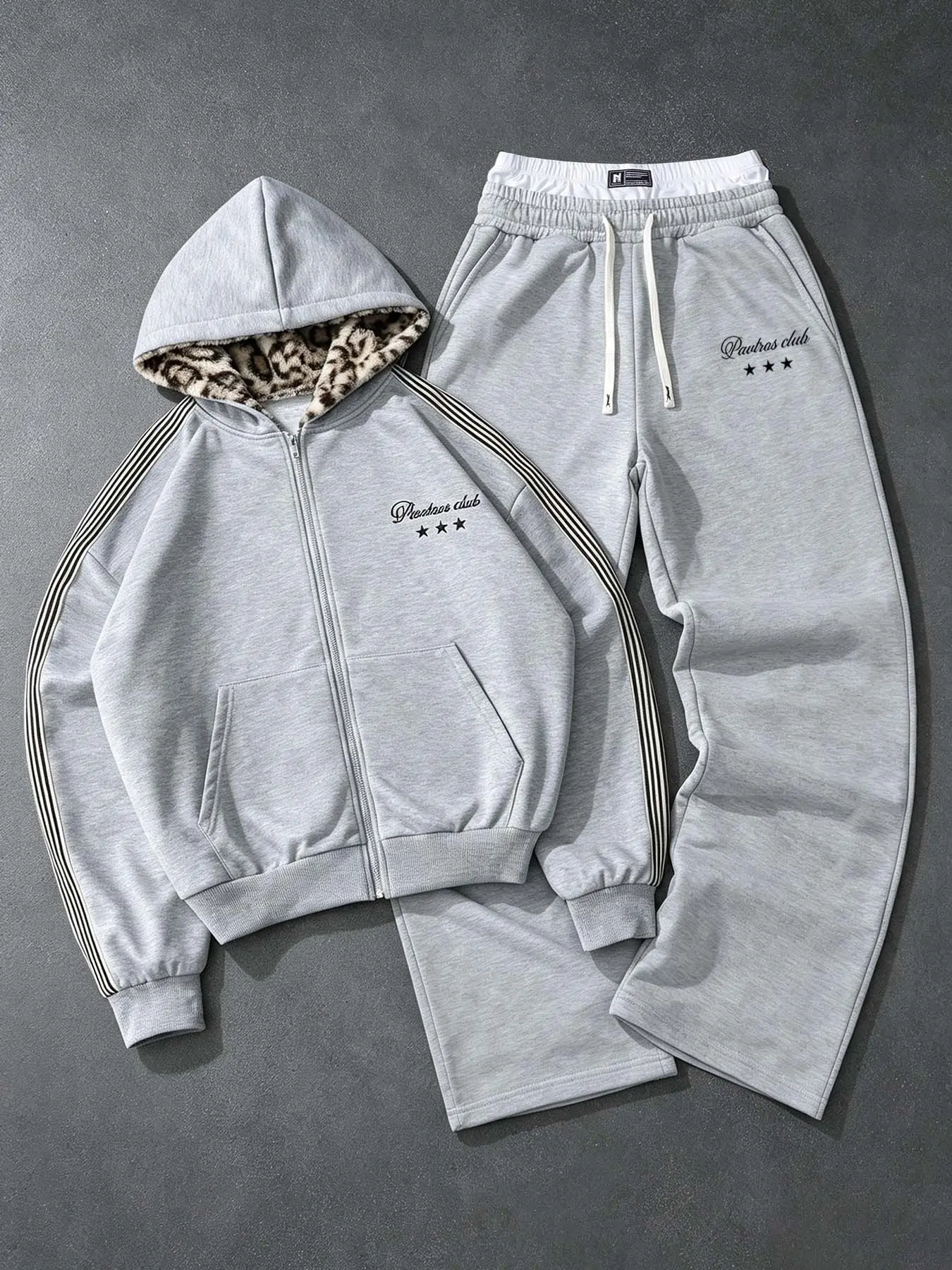 Gray two-piece streetwear sports suit, zip-up hoodie with matching wide-leg sweatpants, drawstring elastic waist, soft and comfortable fabric, everyday urban street style outfit #ZipHoodieSet #Streetwear