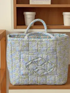 Large capacity floral quilted storage basket with plaid lining and multi-purpose organizer to store makeup, toiletries and daily essentials, perfect for bedrooms, bathrooms, offices and travel