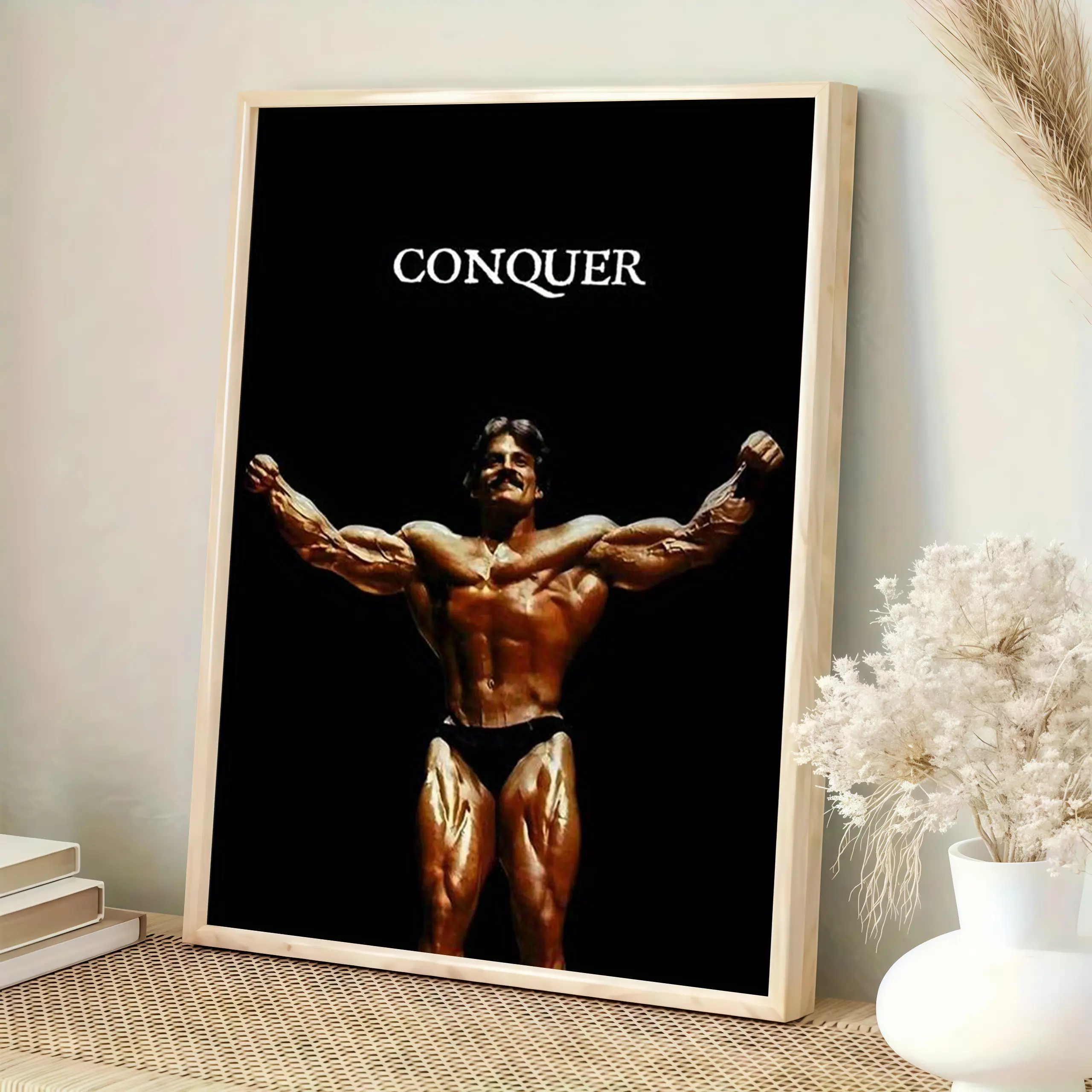 “Don’t just survive—conquer.” A poster of Mike Menzel hangs on the wall, serving as the ultimate motivation for building a home gym.
