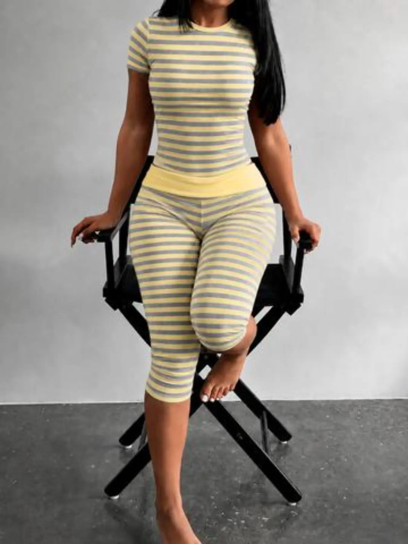 Women's Striped Two-Piece Set Outfits Is Simple Yet Stylish. The Yellow-Grey Round-Neck Short-Sleeved Top Is Paired With High-Waisted Wide-Leg Cropped Trousers, Making It Suitable For Casual Wear At Home, Relaxing Moments, And Everyday Outings.
