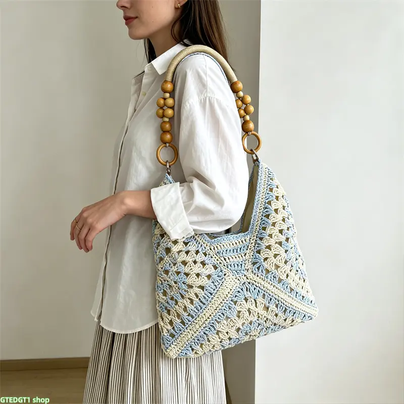 A stylish new handmade woven bag—a versatile paper-cord crochet straw shoulder bag. Perfect for beach and vacation looks, it is lightweight, practical, and a must-have accessory for summer.