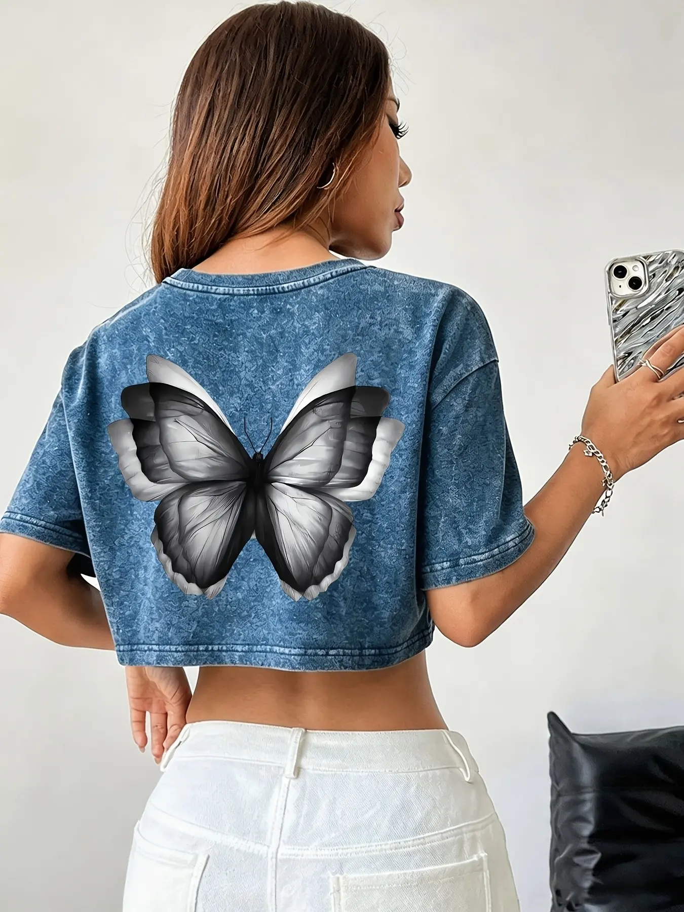 Y2K-style cropped T-shirt Top featuring a butterfly back design and a washed finish. Made from skin-friendly fabric, this loose-fitting, versatile, Casual piece is a head-turner, perfect for store-hopping or hitting the streets with a trendy, edgy vibe