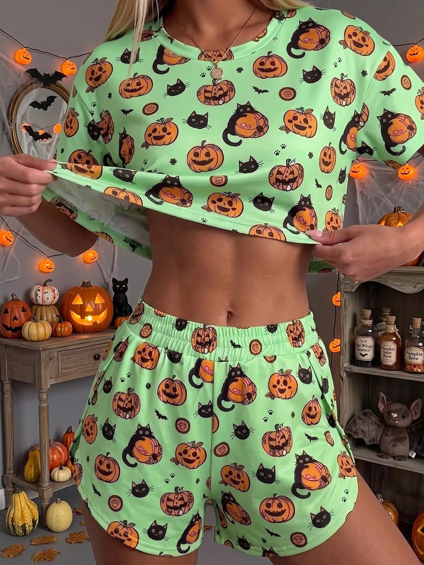 Women's 2-piece Halloween summer pajama set, featuring a pumpkin, bat, and ghost pattern. The loose fit and casual style make it suitable for lounging at home, parties, and everyday holiday wear.