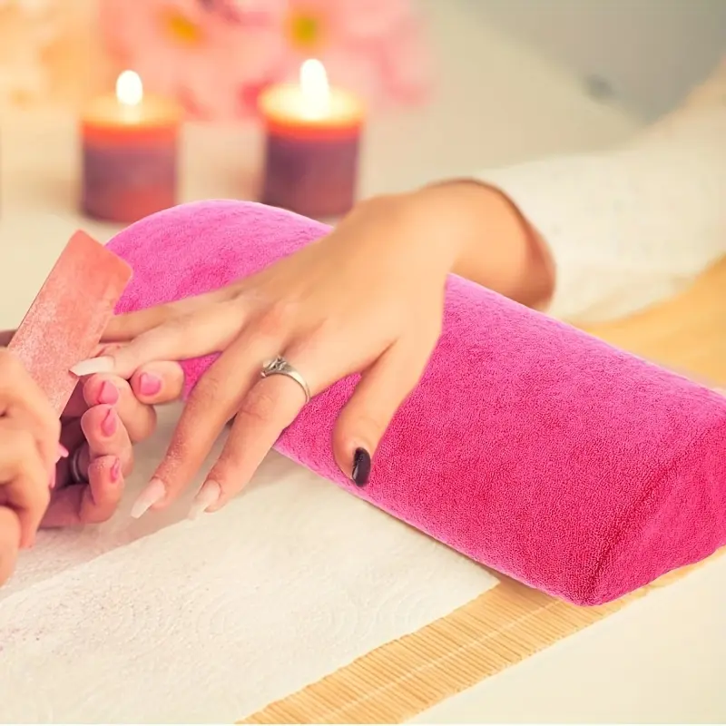 Salon exclusive pink long nail art hand pillow with removable washable towel cover. Soft wrist cushion relieves arm fatigue, fits manicure tables. Detachable outer layer for easy cleaning, essential tool for filing and nail polish application.