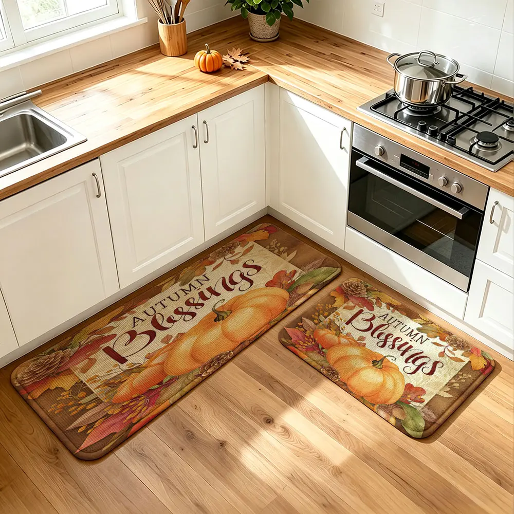 A set of 2pcs pumpkin autumn leaf-themed placemats with "Autumn Blessings" slogan printed on them. They can be machine-washed and are suitable for kitchen use. They are perfect for kitchen decoration, home decoration, and can also be used as gifts.