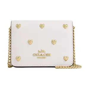 COACH Mini Wallet for Women with Heart-Shaped Studs and Detachable Chain Strap, Pebbled Leather, Chalk White